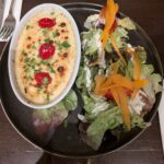 Royan ravioli au gratin with cream and salad.